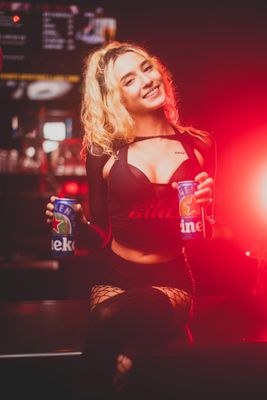 Bartender at Rick's holding two drinks
